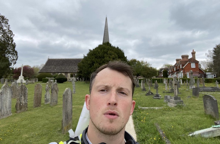 Ellis Tustin takes a selfie in a church graveyard during his journey from Fulham to Brighton.