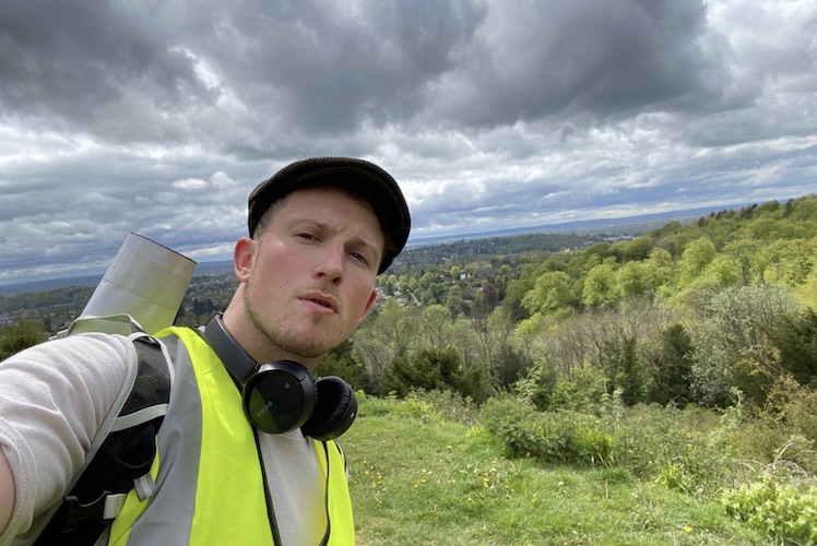 Ellis Tustin takes a selfie in a field during his journey from Fulham to Brighton