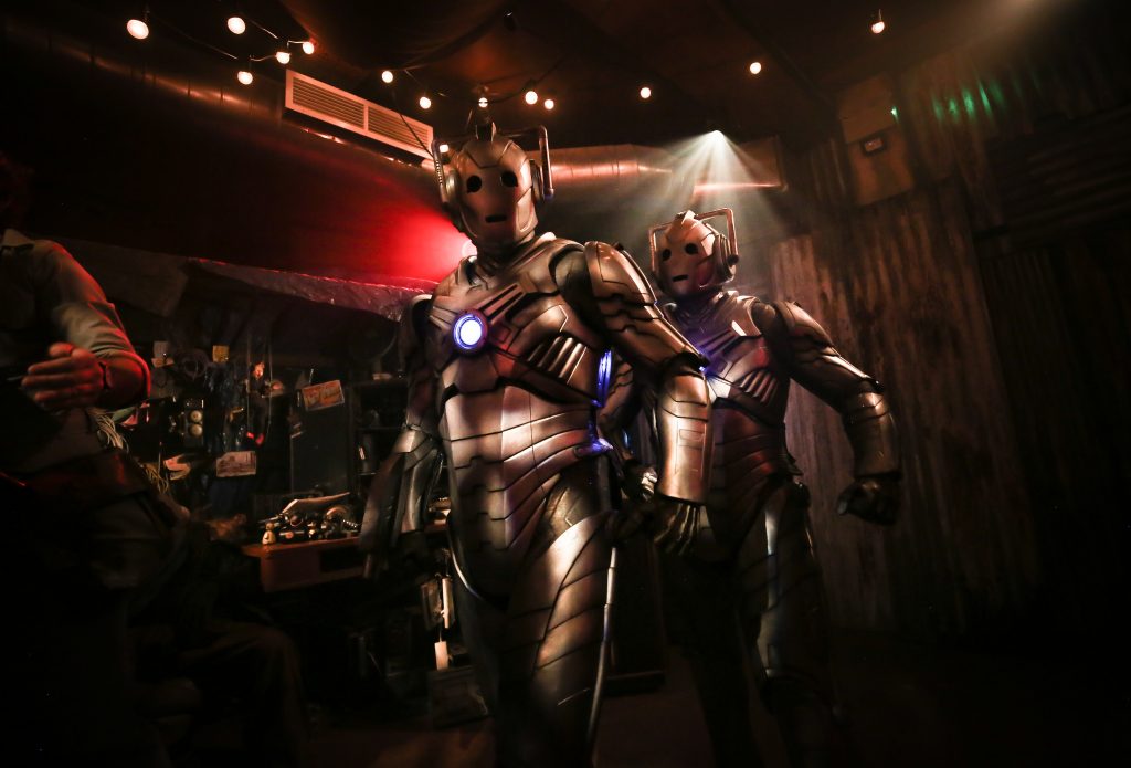 Two Cybermen in an alien marketplace as part of Doctor Who: Time Fracture. Credit: Mark Senior