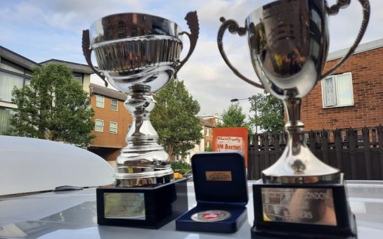 Photo of the cup and league trophy that Minds United FC won
