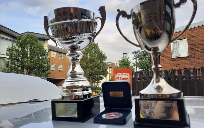 Photo of the cup and league trophy that Minds United FC won