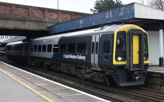 south western railway train waiting at a platform