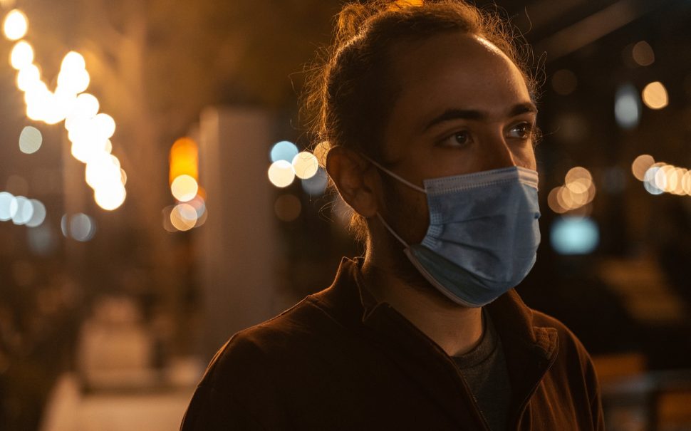 man wearing a mask at night
