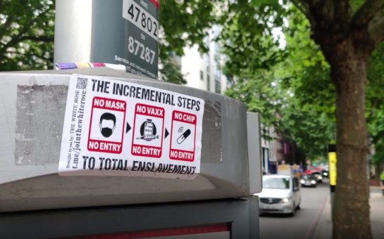 anti vax sticker on a bus stop warning against total enslavement