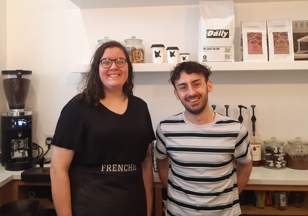 Sarah Farmer and Benito Preite stand behind the counter at Frenchie