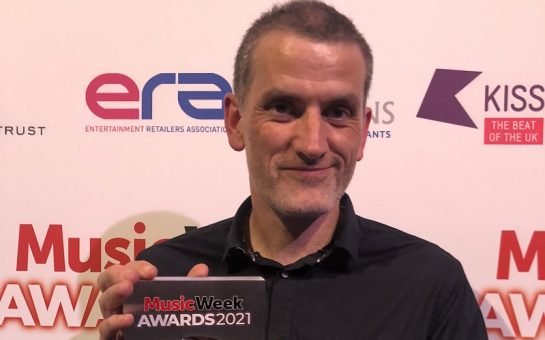 Jon Tolley holding Best Independent Retailer award