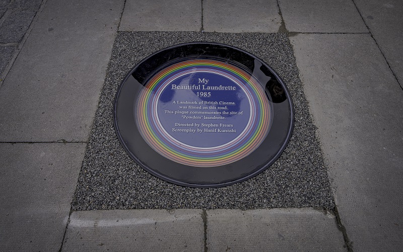 A close-up of the rainbow plaque commemorating "My Beautiful Laundrette" in Lambeth