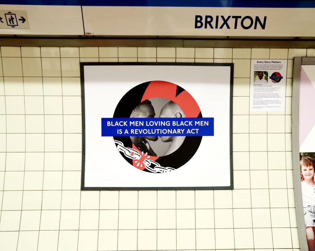 Marc Thompson's Pride roundel in Brixton, featuring two black men kissing, a heart, broken chains and the words "Black men loving black men is a revolutionary act."