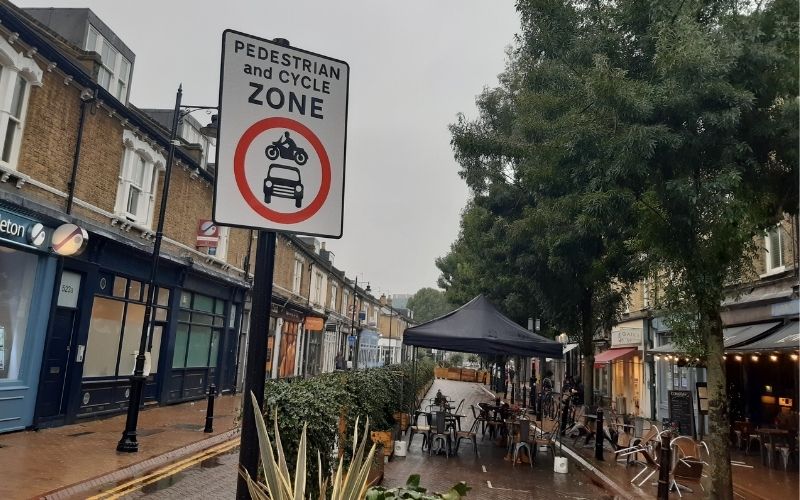 Old York Road with a pedestrianised zone sign and outdoor seating