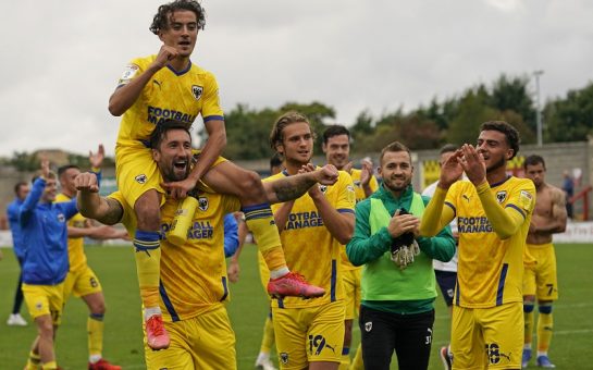 The Wimbledon players celebrating with the fans after their victory over Morecambe FC