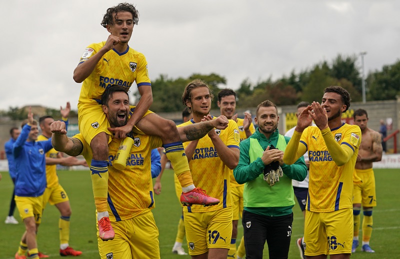 The Wimbledon players celebrating with the fans after their victory over Morecambe FC