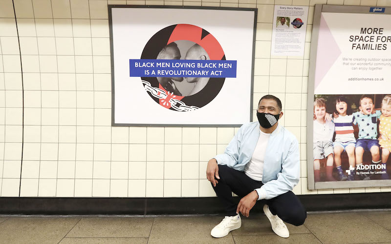 Marc Thompson with his Pride roundel in Brixton Underground station.