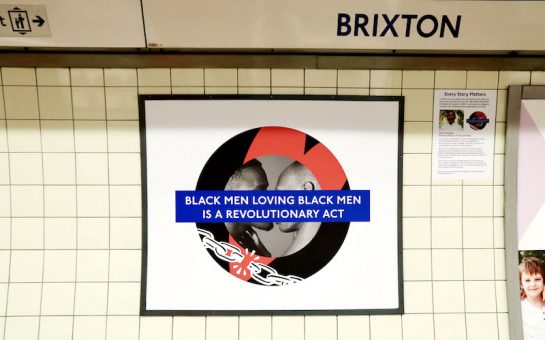 The Brixton Pride roundel featuring two black men kissing with the words “Black men loving black men is a revolutionary act.”