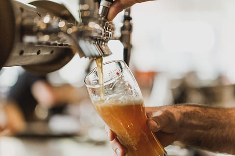 Man pouring pint of beer in a pub