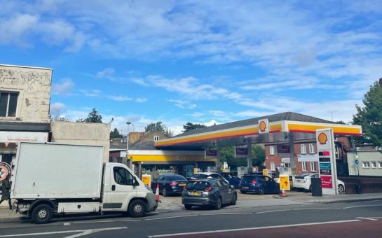 Several cars and a white van crowd the forecourt at a Shell petrol station in Twickenham