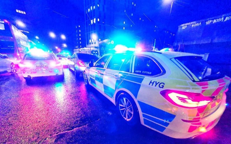 police cars with lights flashing at night