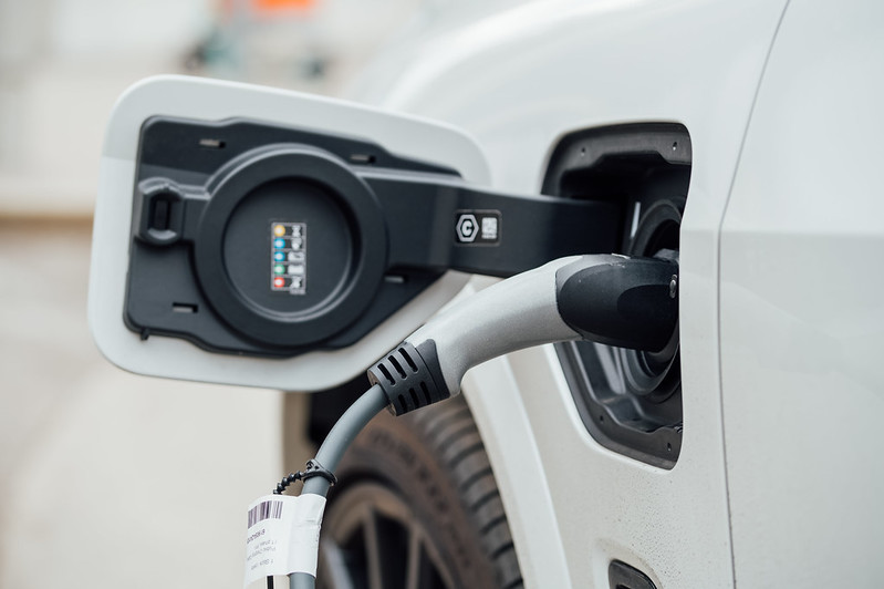 Public charging station cable plugged into an electric car