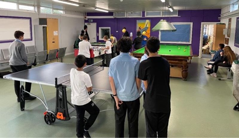 Children laying table tennis and pool in the community centre
