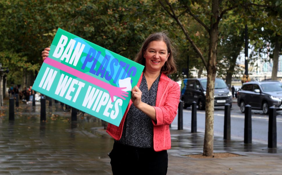 fleur anderson holding up 'ban plastic in wet wipes banner