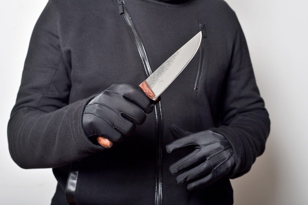 A person holding a knife in their right hand.