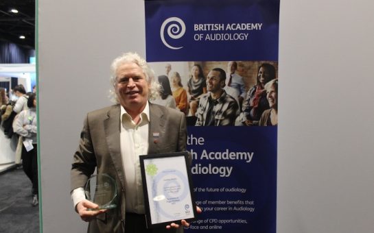Geoff Whitby with the Peggy Chalmers Audiologist of the Year award.
