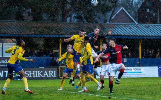 Hampton and Richmond Players Compete for the ball