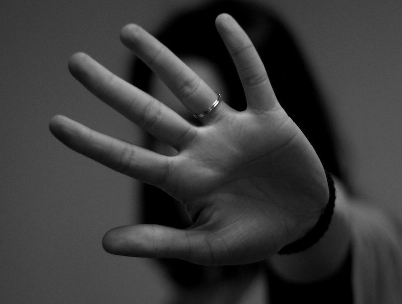 person holding up hand to the camera