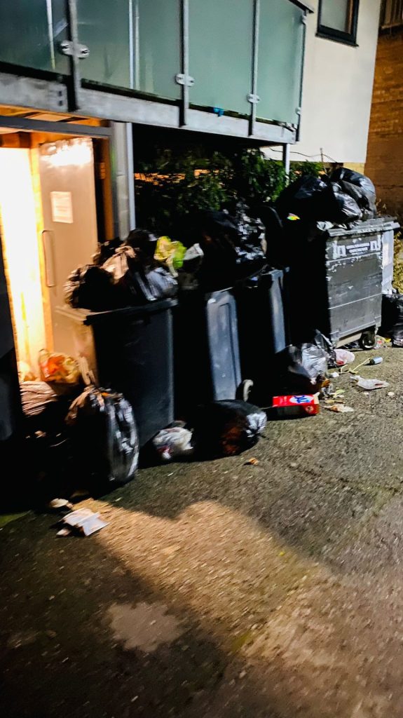 Bins and rubbish blocking the emergency exit