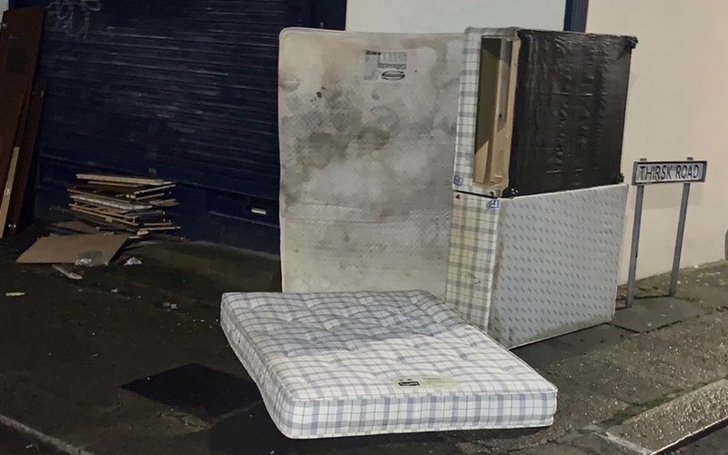 A mattress is shown dumped on a Mitcham street corner.