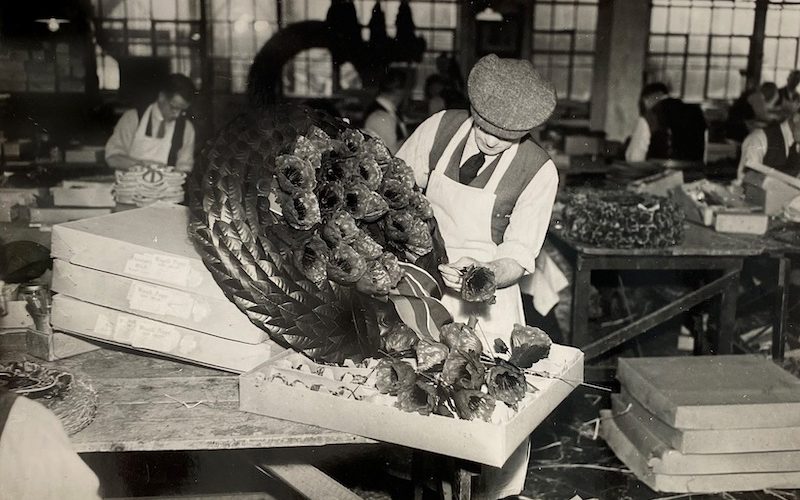 Factory worker makes a remembrance wreath.