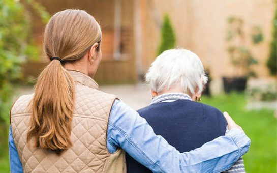 woman helping elderly man