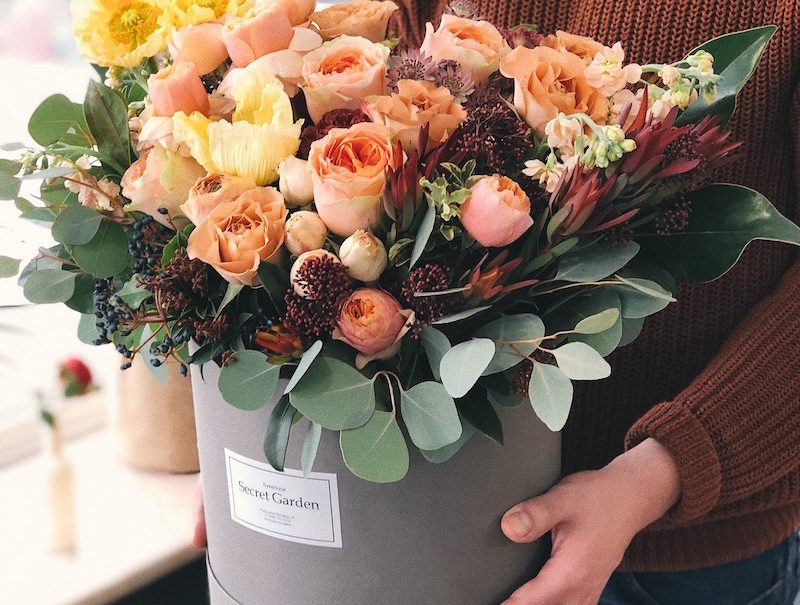 person holding rose bouquet