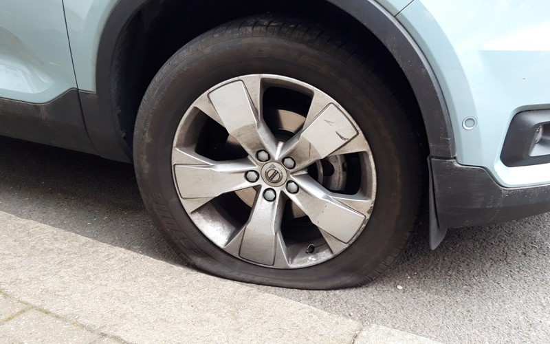 A car with a deflated tyre in Clapham