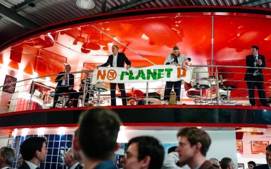 Extinction Rebellion members unfurl a banner that reads No Planet B