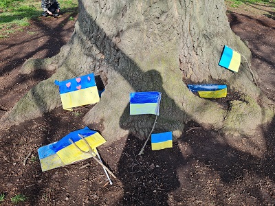 Ukraining flags by base of tree of peace