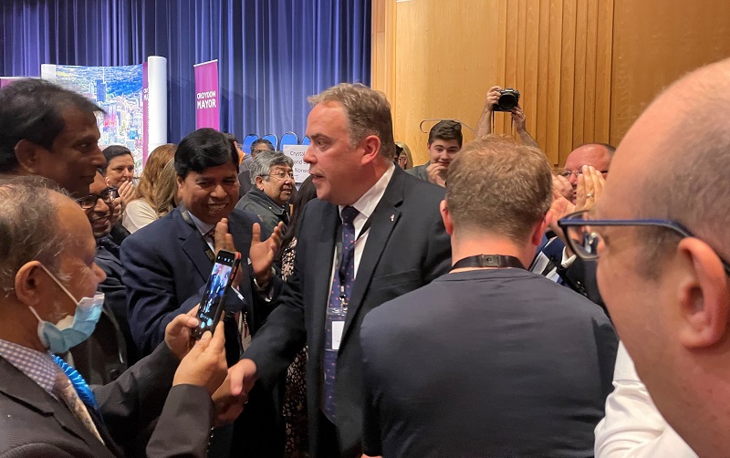 jason perry surrounded by reporters and councillors