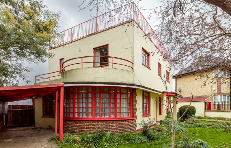 A detached house in the moderne style, designed by Leslie H Kemp and Frederick E Tasker and built by Cyril and Stanley Morrell 1935-1936. The house has external walls of rendered brick, with metal casement windows and a flat, concrete roof. The original house is rectangular on plan, with a projecting, curved bay to the south elevation at ground floor level. The front (east) elevation is at an oblique angle to the street while the adjacent garage to the north is perpendicular to the street. It retains several of its original features, including the bathroom fittings, iron staircase, Crittall windows and a roof terrace. At ground-floor level the semi-circular bay has exposed red brick laid in Flemish bond and a continuous, curved window. General view of exterior from south east.