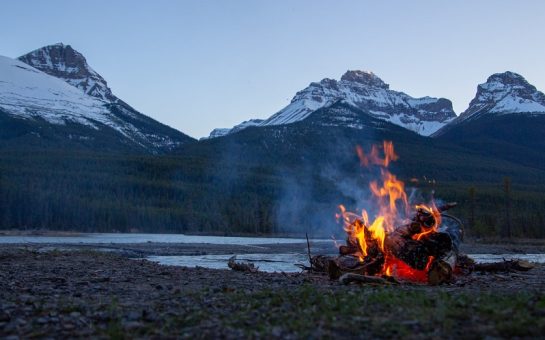 campfire against mountain backdrop