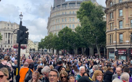 Crowds gather to catch a glimpse of the Queen's coffin