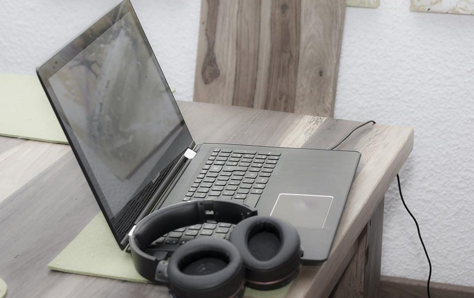 A laptop and headphones on a desk