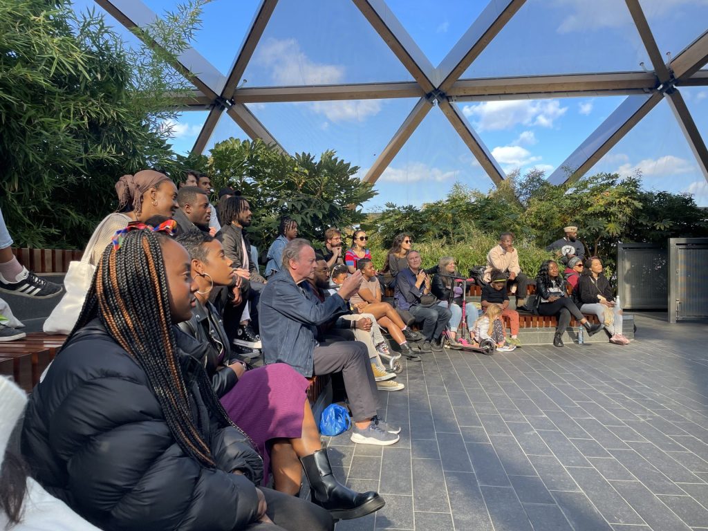 Audience members watch as Theresa Lola performs on stage