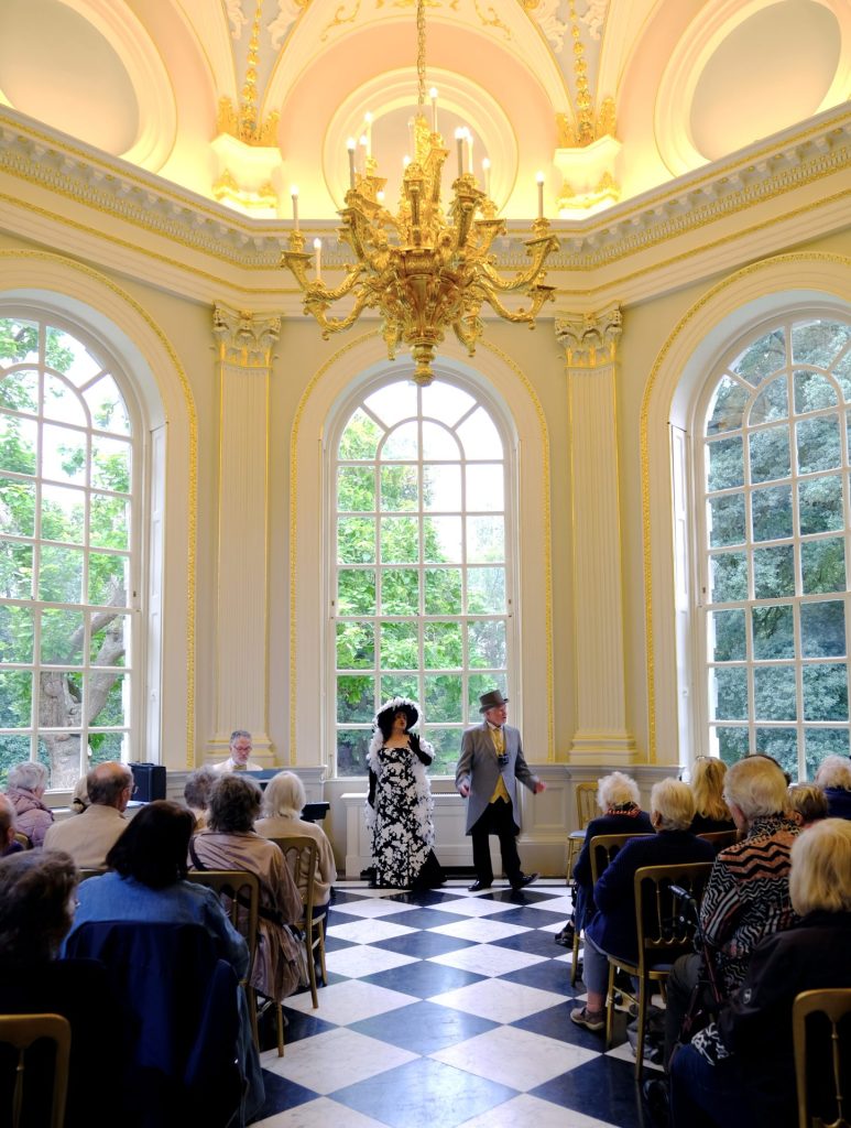 Members of the Connaught Opera performing underneath a chandelier in the Octagon Room