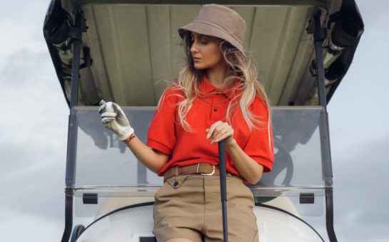 A woman dressed in golfing attire