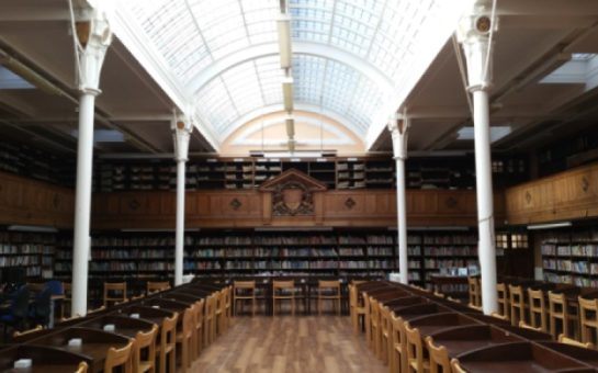 The interior of Battersea library in Wandsworth. There are rows of desks and bookshelves