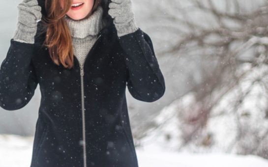 A woman in a winter coat in the snow