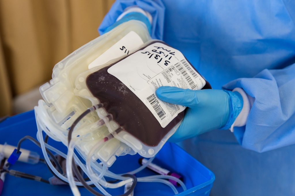 Doctor carying a pouch with donated blood.