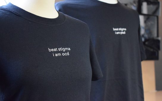 A black t-shirt which says 'beat stigma, I am OCD'