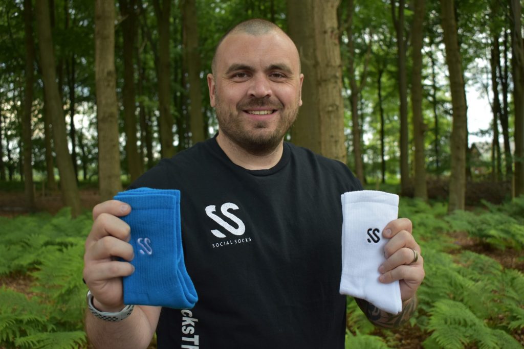 Marc Bucci founder of Social Socks plants a tree with every order and uses plastic free materials and packaging