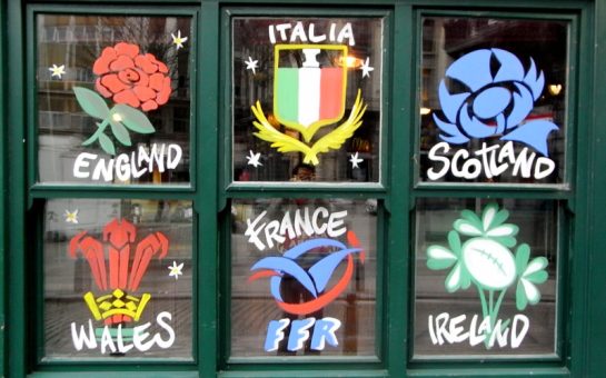 The badges of each Six Nations side painted onto a window pane.