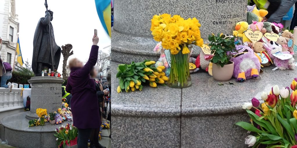 Toys for remembrance of the young people who died in the Ukraine war over the past year, piled up with flowers next to the St Volodymyr statue